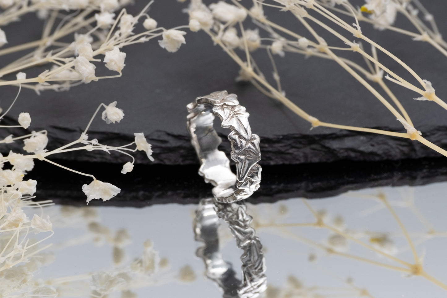 a silver ivy leaf ring on a mirror