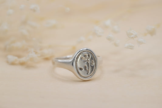 a silver floral signet ring