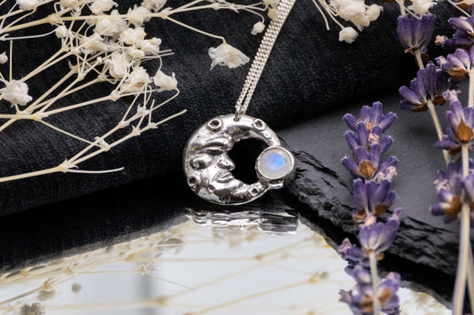 man in the moonstone silver pendant on mirror with lavender