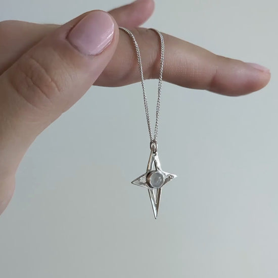 video of my magic moonstone star pendant hanging from my hand