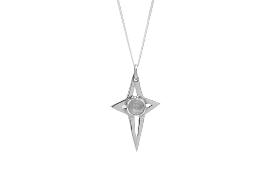 a star shaped silver pendant with a moonstone on a white background