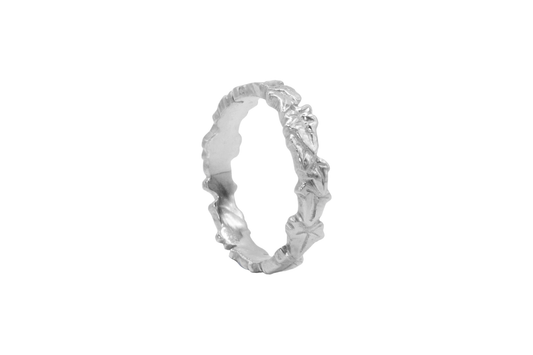 a slim silver ivy leaf ring on a white background